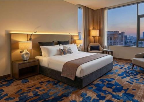 a hotel room with a bed and a large window at La Terrasse Hotel in Jeddah