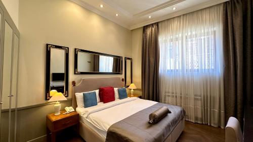 a hotel room with a bed and a window at Seven Rooms Boutique Hotel in Baku
