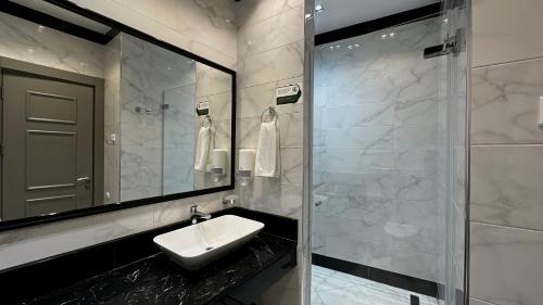 a bathroom with a sink and a mirror at Seven Rooms Boutique Hotel in Baku