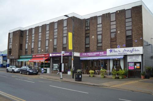 a large brick building on a city street at Star Anglia Hotel City Center by OYO in Colchester