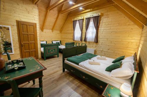 a bedroom with a bed in a wooden room at Székelyföld,Siklódi Kő Vendégház, Csűr in Şiclod