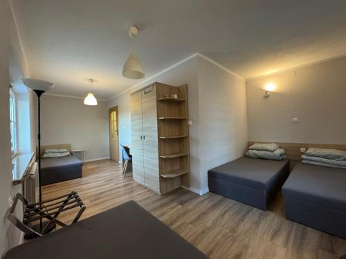 a small room with two beds and a desk at Dom Nad Brzegiem Wisły in Mozolice Małe