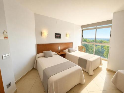 Postel nebo postele na pokoji v ubytování Hotel Avenida El Morell