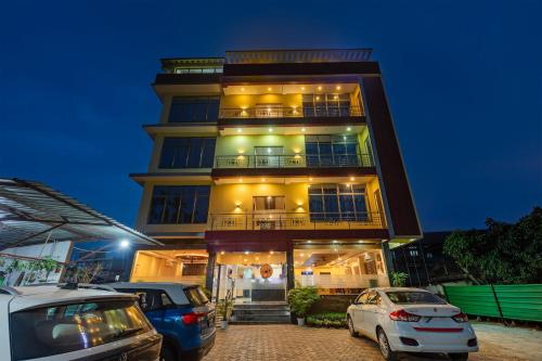 a building with cars parked in front of it at Treebo Hotel Mobi VIP Airport in Guwahati