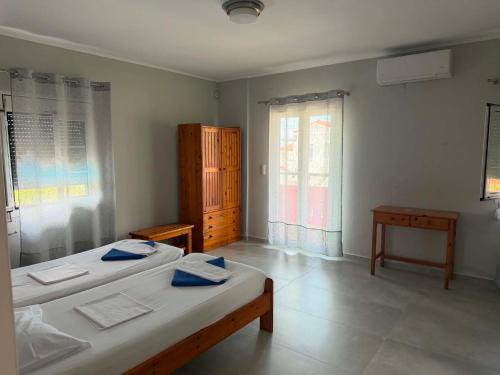 a bedroom with two beds and a window at Albatross in Marathokampos