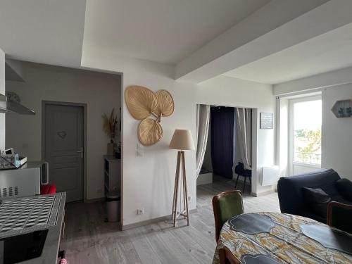 a living room with a table and a living room with a room at Appartement privé « Rive Droite » in Serrières