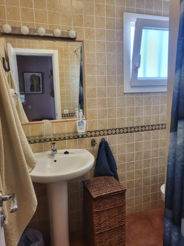a bathroom with a sink and a mirror at Villa Acoran in Costa Teguise