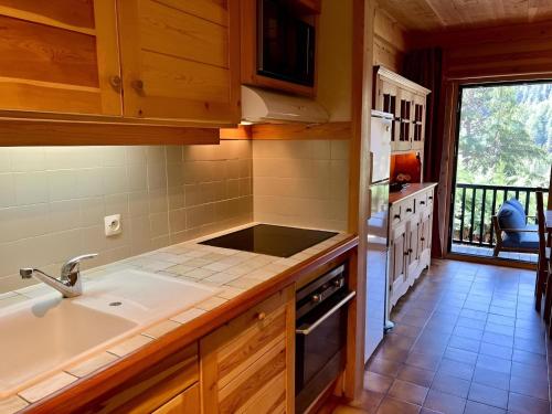a kitchen with a sink and a stove at Triplex 8 people 4 bedrooms in Saint-Chaffrey