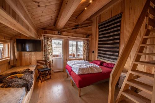 a bedroom with a bed in a wooden room at Langedrag Naturpark in Tunhovd