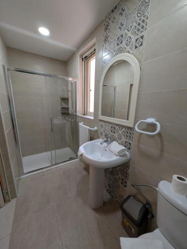 a bathroom with a sink and a shower at Ta Robert Farmhouse in San Lawrenz