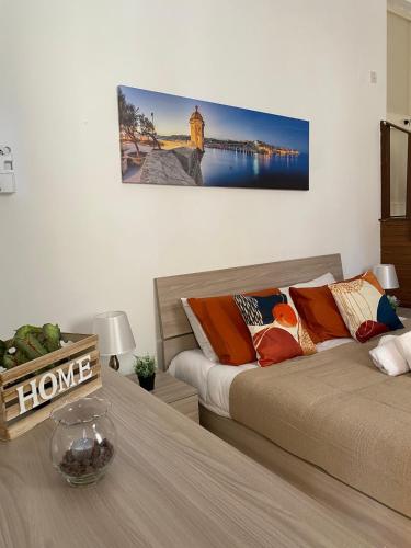 a bedroom with two beds and a table with a picture on the wall at Ta Robert Farmhouse in San Lawrenz