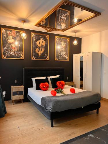 a bedroom with a bed with red flowers on it at R.Suite in Saint-Étienne