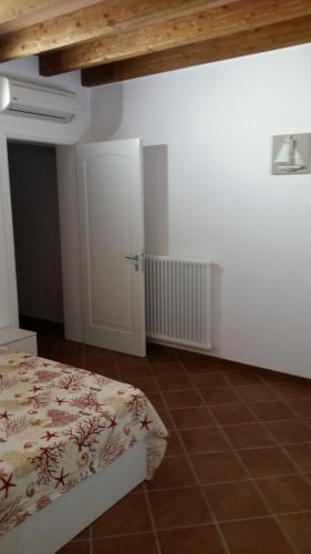 a bedroom with a bed and a white door at Villa Sofia in Marina di Campo