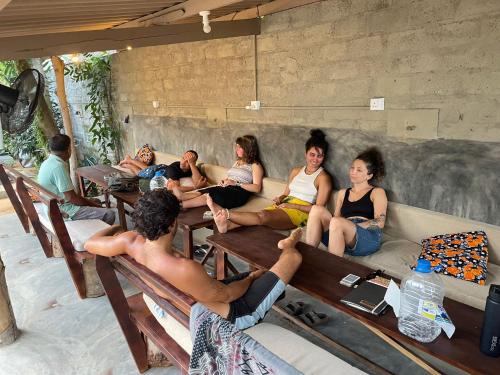 a group of people sitting on a couch at Uluwatu Surf Hostel - Arugambay in Arugam Bay