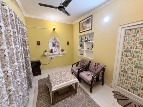 a waiting room with two chairs and a table at Staylo Suites Edit in New Delhi