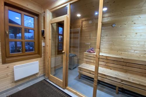 a sauna with wooden walls and a window at Székelyföld,Siklódi Kő Vendégház, Csűr in Şiclod