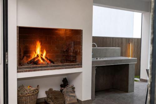 a fireplace in a bathroom with a sink at Taluga Beach Villa in St. Helena Bay