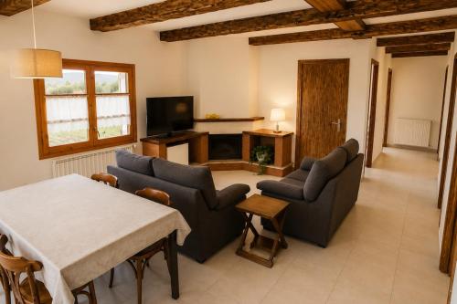 a living room with two couches and a table at Winahost Espunyola Berga in L'Espunyola