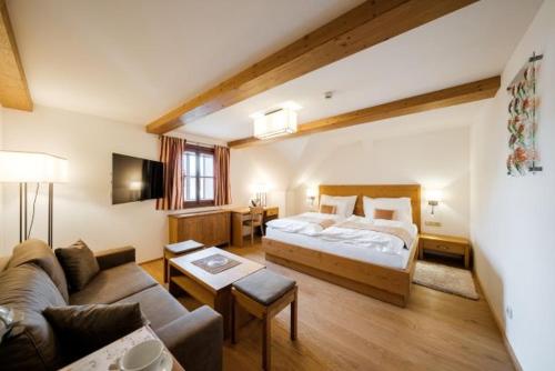 a hotel room with a bed and a couch at U Černého medvěda in Jablonné nad Orlicí