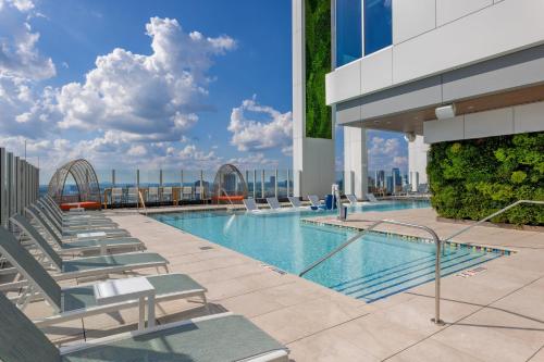a pool on the roof of a building with lounge chairs at Atlanta Resort 1BR Apartment in Atlanta