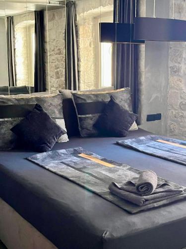 a bed with a magazine on top of it at Mala Porta in Trogir