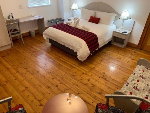 a bedroom with a bed with a teddy bear on it at Savoy Hotel Beaufort-West in Beaufort West