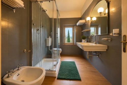 a bathroom with a tub and a sink and a shower at Terracqua Retreat I Essence of Tuscany in Chiusi