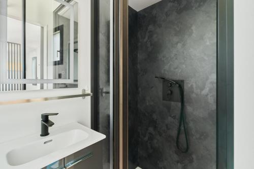 a bathroom with a sink and a shower at Le Cocon de Brocéliande - Studio cosy et indépendant in Saint-Thurial