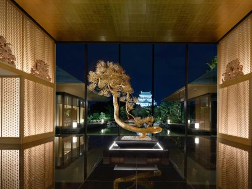 a room with a tree in the middle of a building at Espacio Nagoya Castle, The Leading Hotels of the World "LHW" in Nagoya