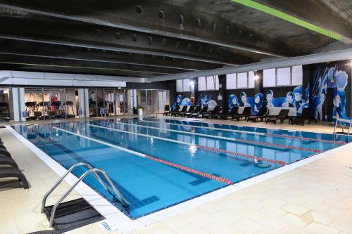 a large swimming pool in a large building at Hotel Moldova in Iaşi