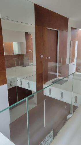 a bathroom with a glass counter with three sinks at Appartamenti Ariston - Centro Giulianova in Giulianova