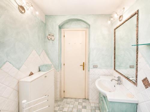 a bathroom with a sink and a mirror at Casa al mare Porto Sole in Baja Sardinia