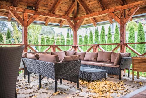 a patio with a couch and chairs and a table at CenterCity Apartments in Prešov