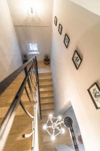 a hallway with a staircase with pictures on the wall at CenterCity Apartments in Prešov