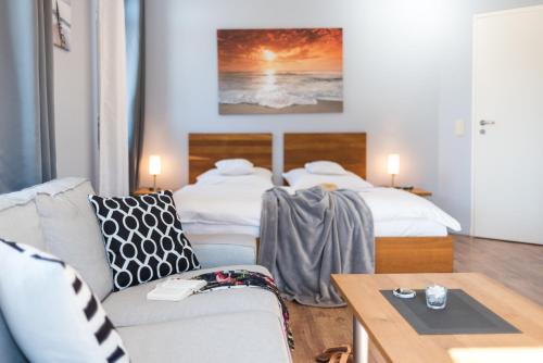 a living room with two beds and a couch at Neue Galerie App 3 in Ahrenshoop