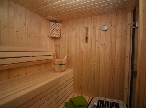 a cabin with a sauna with a clock on the wall at Ostseefeeling in Wustrow