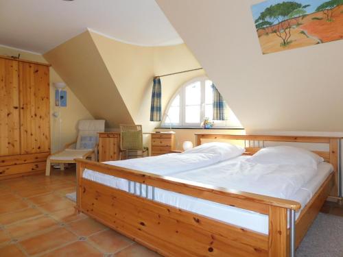 a bedroom with a large bed in a attic at Haus Tina in Ahrenshoop