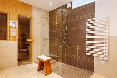 a bathroom with a shower with a glass door at Suite Meeresrauschen in Ahrenshoop
