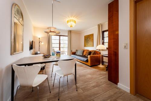 a dining room and living room with a table and chairs at Anker Haus Sanddorn in Althagen