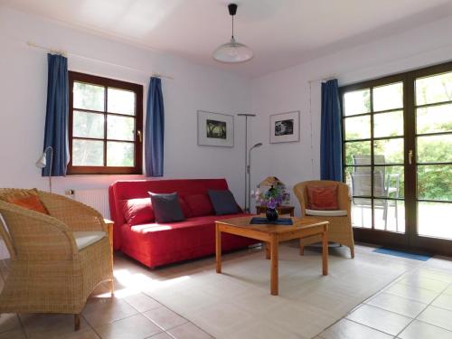 a living room with a red couch and chairs at Luv in Althagen