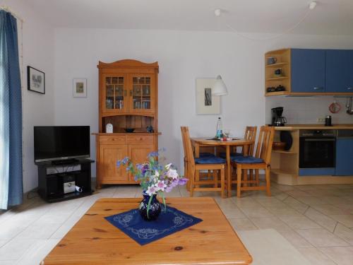 a living room with a vase of flowers on a table at Luv in Althagen