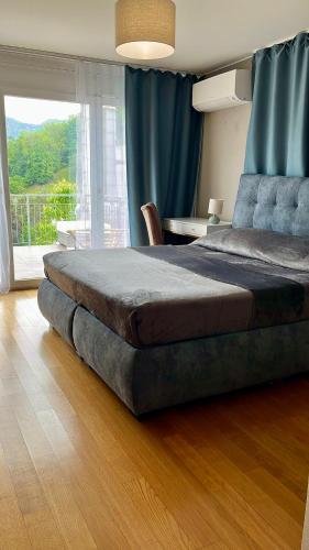 a bedroom with a large bed with a table and a window at Alpen Panorama view Luxury House with green Garden in Buchs
