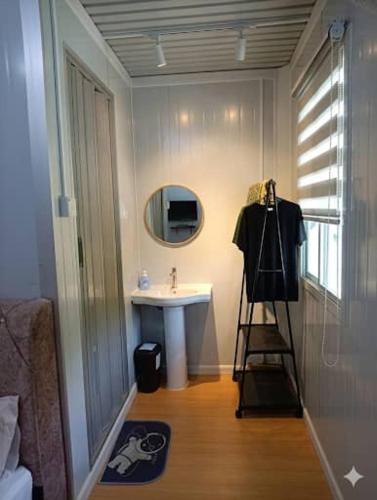 a bathroom with a sink and a mirror at D'Cabin Roomstay in Sungkai