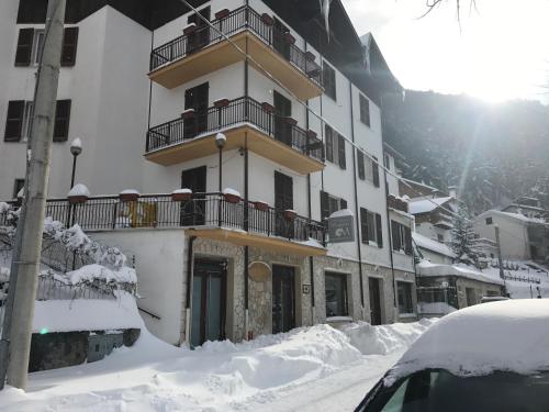a building with snow in front of it at Hotel Margherita in Scanno