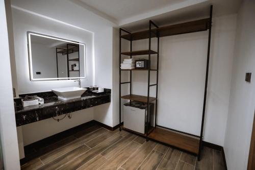 a bathroom with a sink and a mirror at The Wang Yaowarat Hotel in Bangkok