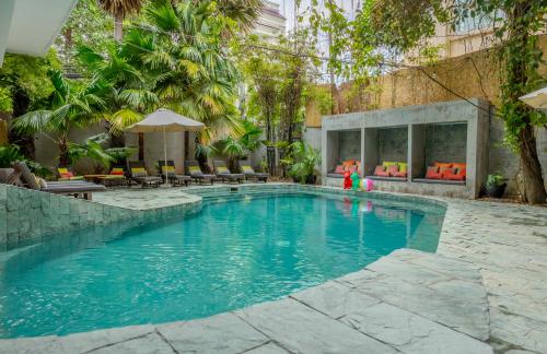 a swimming pool in a hotel with two children playing in it at Sonitori Boutique Resort in Phnom Penh