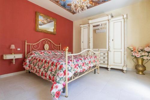 a bedroom with a bed and a red wall at La Terrazza sul Lago in Capodimonte