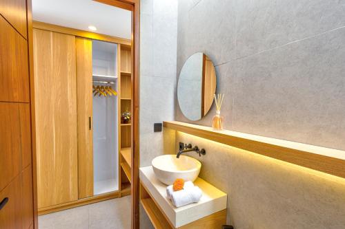 a bathroom with a sink and a mirror at Tapan Harmony Villa Ubud in Ubud