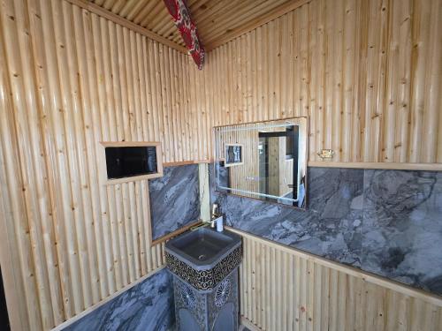 a bathroom with a sink and a mirror at Golden Emir Residence in Bukhara