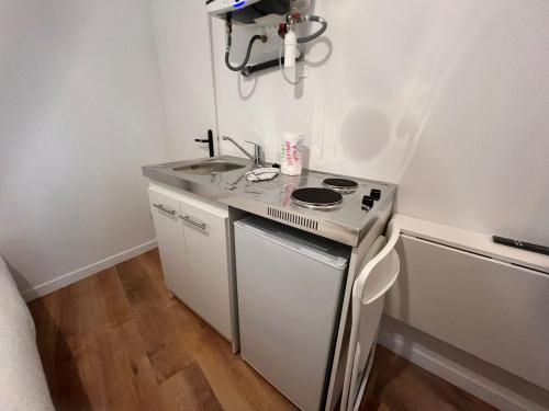 a small kitchen with a stove and a sink at Studio Opale in Lille